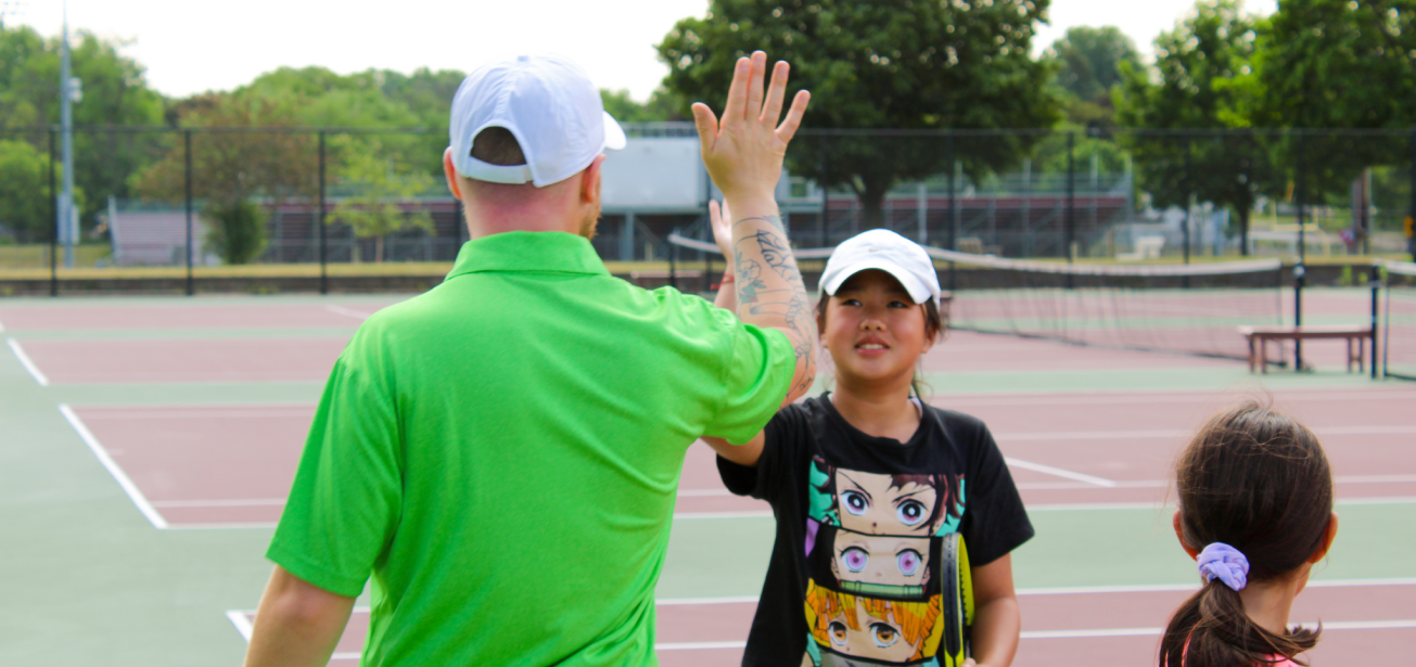 sput coach high five with student